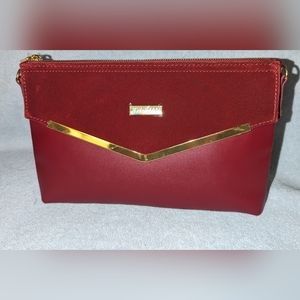 Joy & Iman couture cabernet leather clutch .